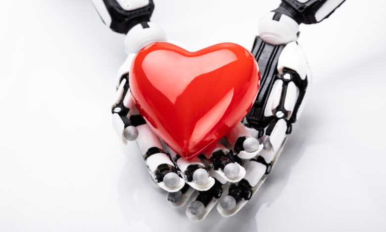 Elevated,View,Of,Robotic,Hand,Holding,Red,Heart